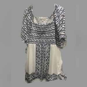 An easy babydoll silhouette with an intricate border print. New without tag!